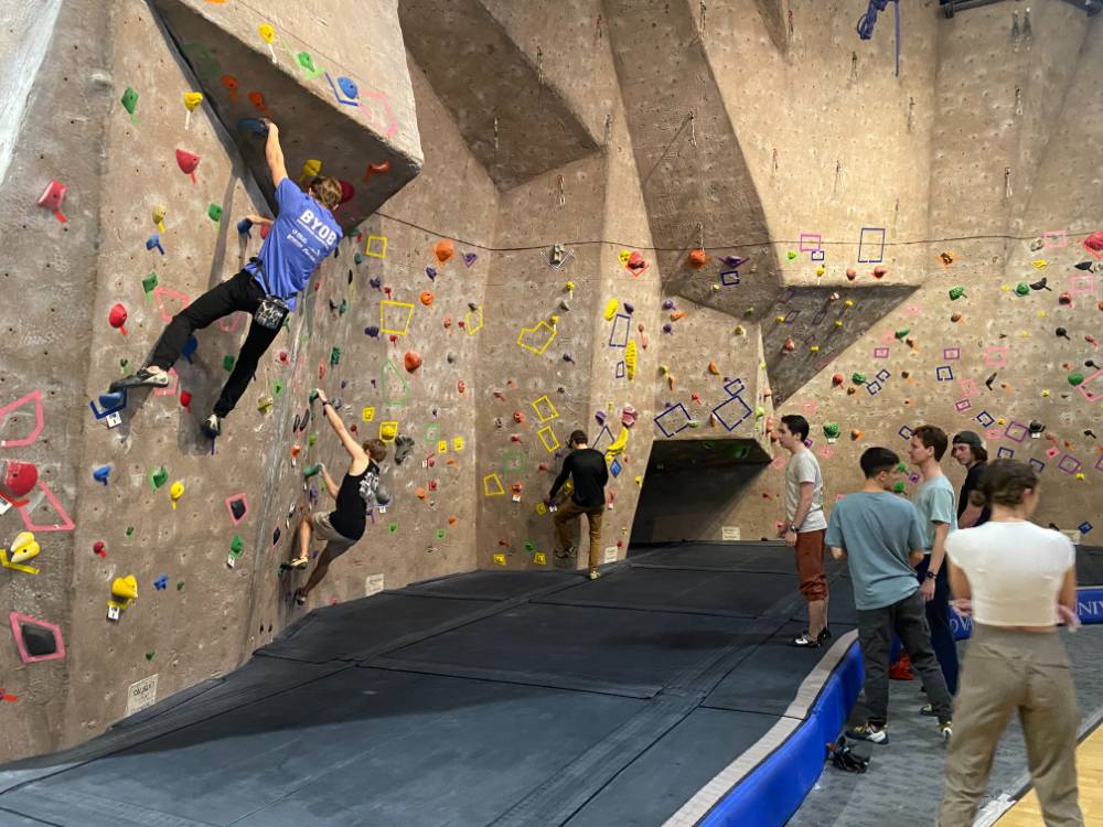 competitors climbing along the wall